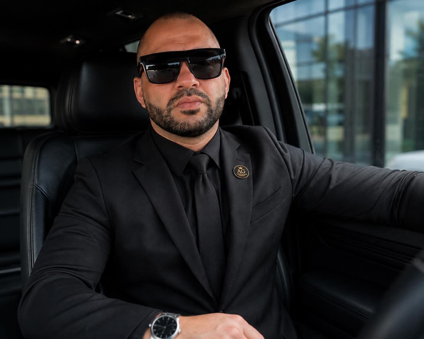 Andre Gomes, founder and executive chauffeur of AG Obsidian Crown, inside a luxury black vehicle